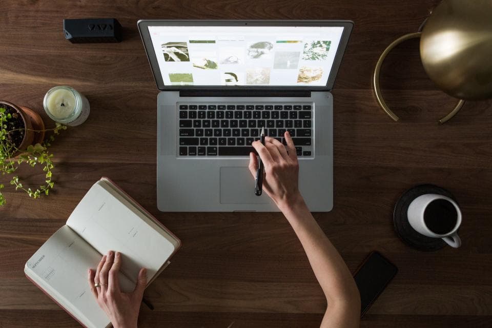 A laptop and open notebook ready for an online lesson